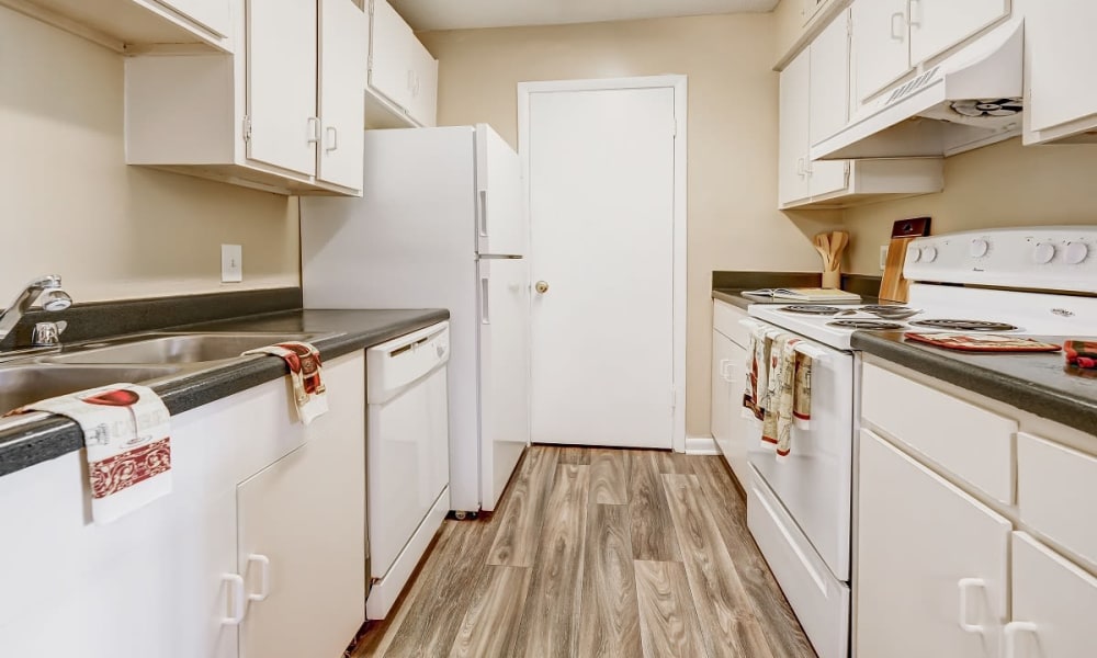Kitchen with white cabinets and appliances at Forestbrook Apartments & Townhomes in West Columbia, South Carolina