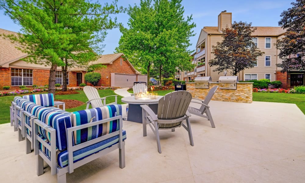 Resident patio area with firepit, seating and grills at Club at North Hills in Pittsburgh, Pennsylvania