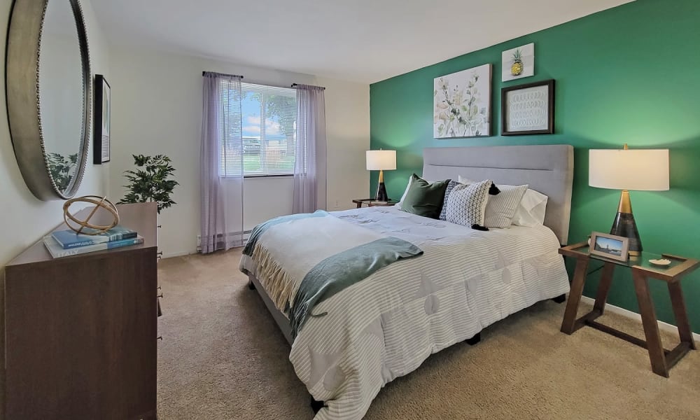 Luxurious and spacious bedroom with access to natural lighting at Westpointe Apartments in Pittsburgh, Pennsylvania