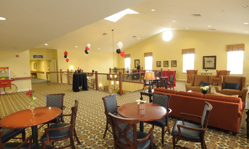 Upstairs dining room with resident lounge area with seating at The Birches of Lehigh Valley in Easton, Pennsylvania