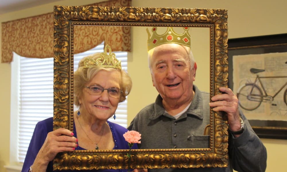 Resident couple posing in a photo frame at The Birches of Lehigh Valley in Easton, Pennsylvania