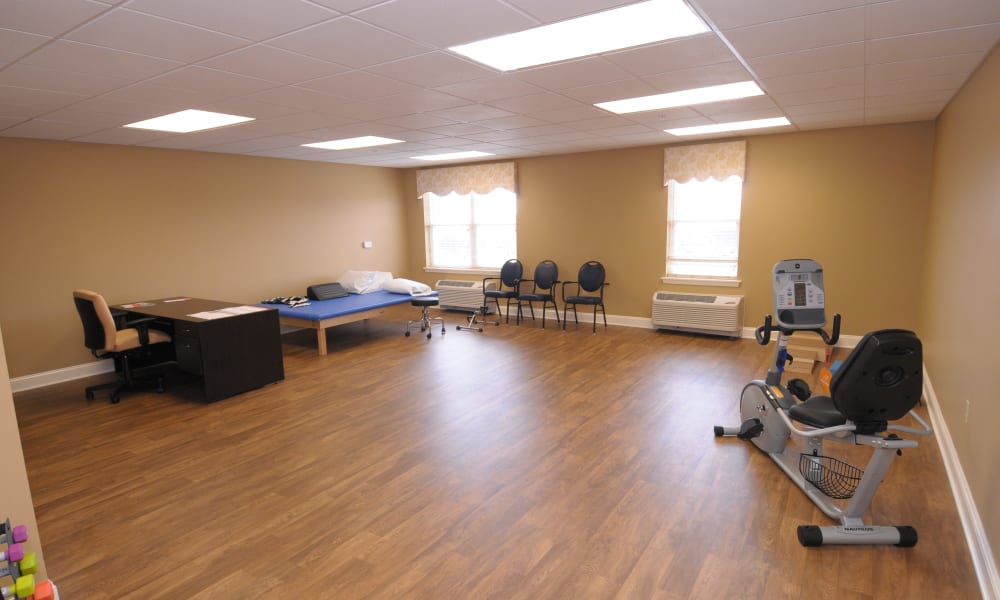 Physical therapy room with workout equipment at The Birches of Lehigh Valley in Easton, Pennsylvania