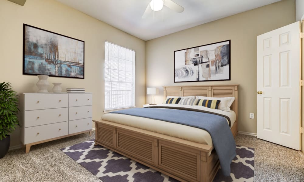 Bedroom with large window at Champion Lake Apartment Homes in Shreveport, Louisiana