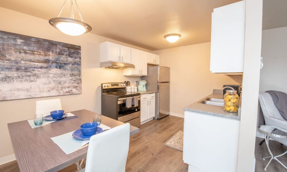 Modern appliances and dining rooms at Cierra Commons Apartments in Burien, Washington