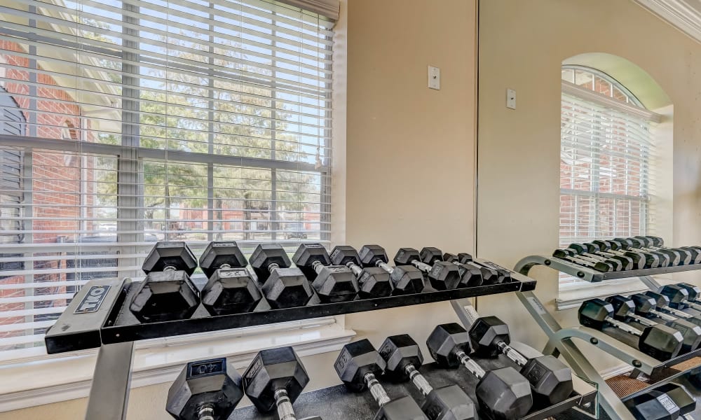 Free-weights in the fitness center at Champion Lake Apartment Homes in Shreveport, Louisiana