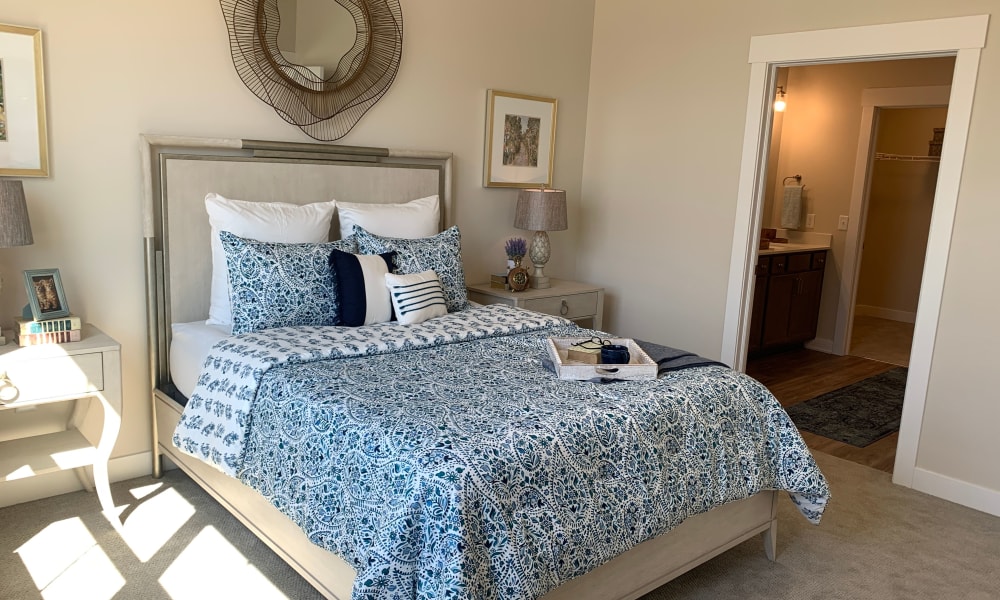 Furnished cottage bedroom with full size bed and matching end tables at Randall Residence at Gateway Park in Greenfield, Indiana