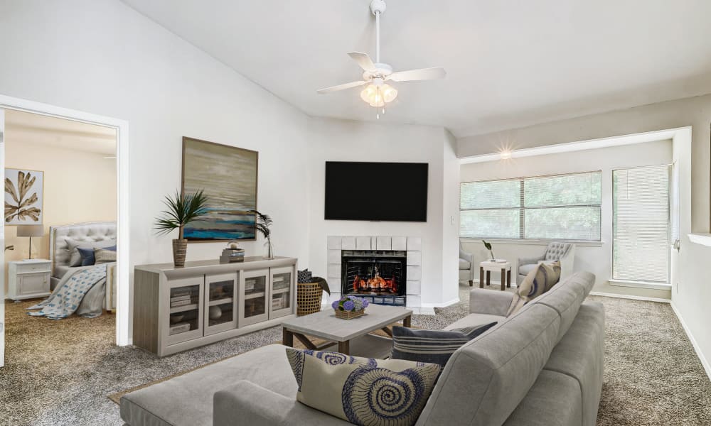 Large living room with a fireplace at Grove at Stonebrook Apartments & Townhomes in Norcross, Georgia