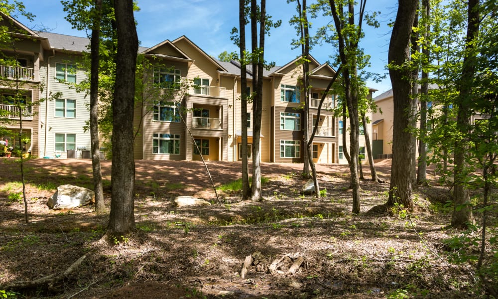 Exterior of an apartment building and surrounding landscape at Bradley Park Apartments in Cumming, Georgia