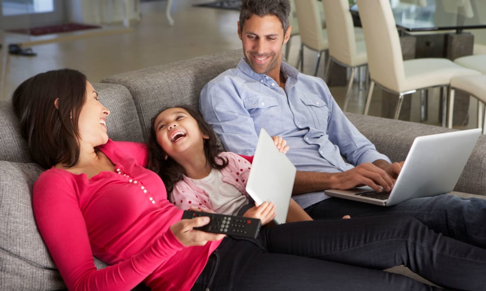 Residents on their electronics laughing together at Chisholm Pointe in Oklahoma City, Oklahoma