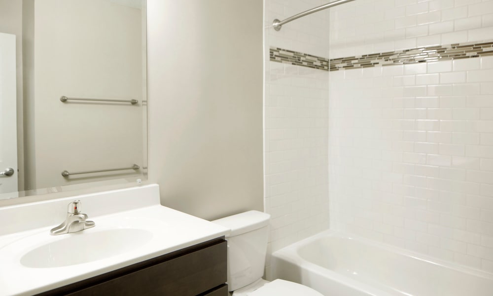 An apartment bathroom with backsplash at Timberlawn Crescent in North Bethesda, Maryland