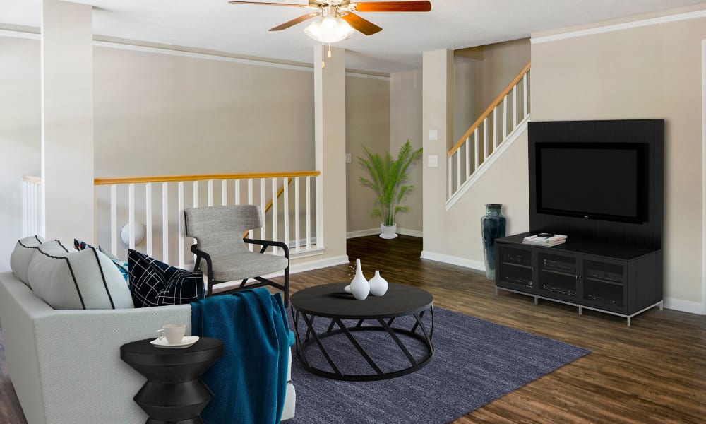 An apartment living room with television and couch at Timberlawn Crescent in North Bethesda, Maryland