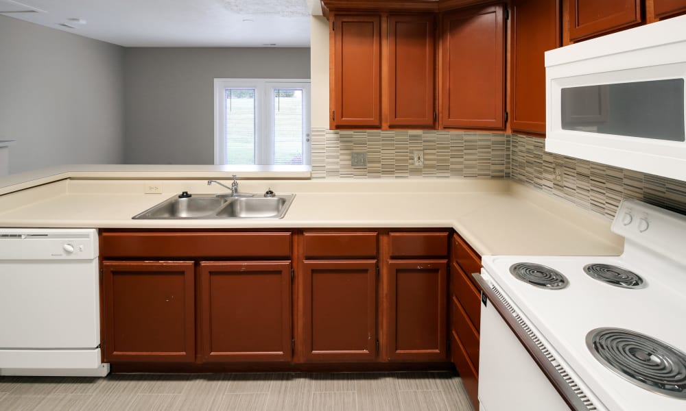 Kitchen with white appliances and tile backsplash