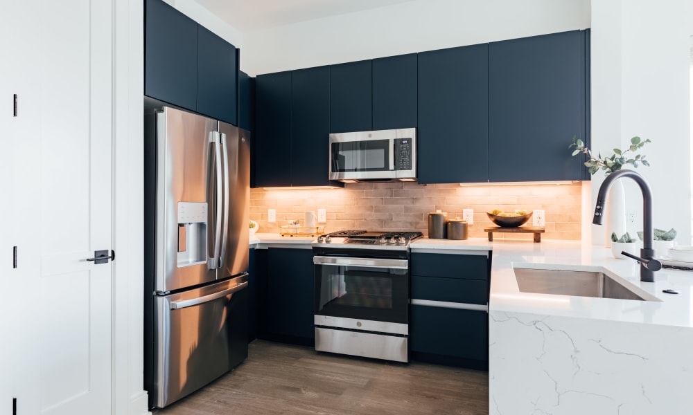 Dark blue cabinets in an apartment kitchen at Citizen in Atlanta, Georgia