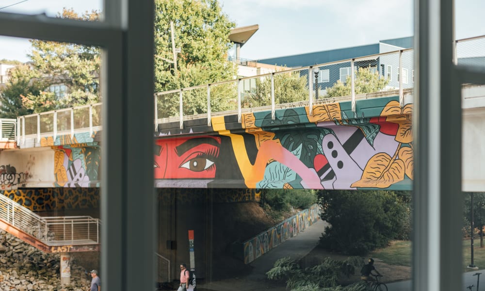 View of a walking path under a painted bridge next to Citizen in Atlanta, Georgia