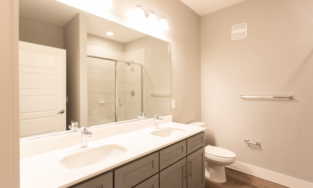 Bathroom with dual sinks at Coronado on Briarwood in Midland, Texas