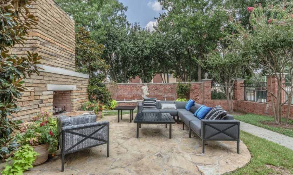 Outdoor seating area with a fireplace at The Livingston in Plano, Texas
