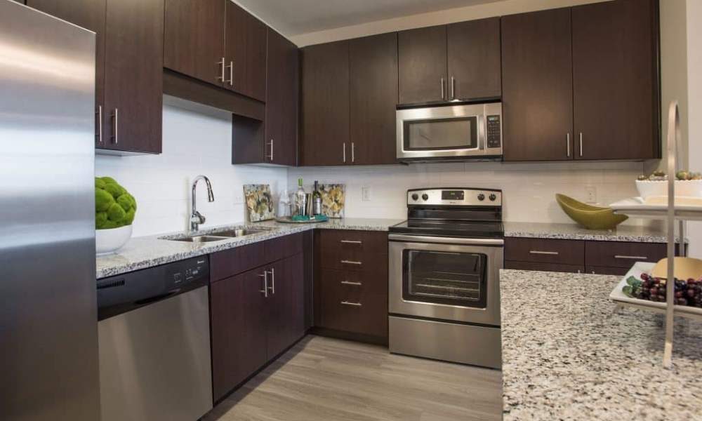 Kitchen with stainless-steel appliances, granite countertops and a refrigerator at Elevation @ County Line Station in Englewood, Colorado