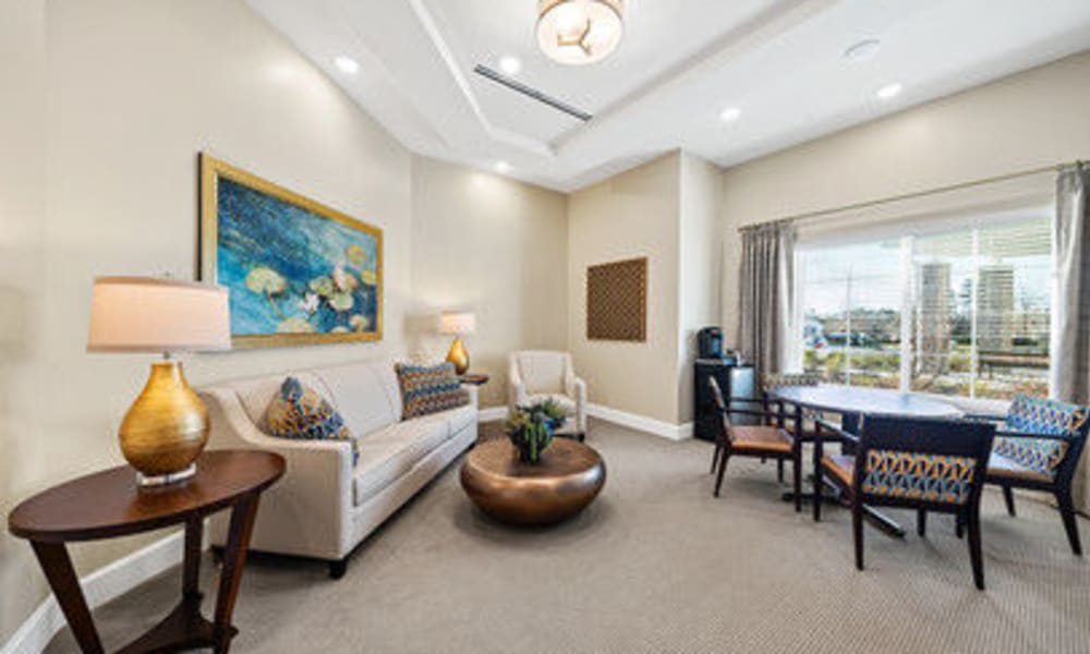 Resident recreation room with sofa and chairs at The Meridian at Carolina Lakes in Indian Land, South Carolina