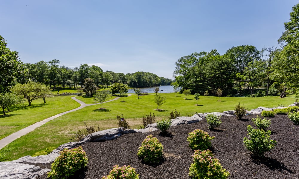 Park-like atmosphere with walking path to lake at Green Lake Apartments & Townhomes in Orchard Park, New York