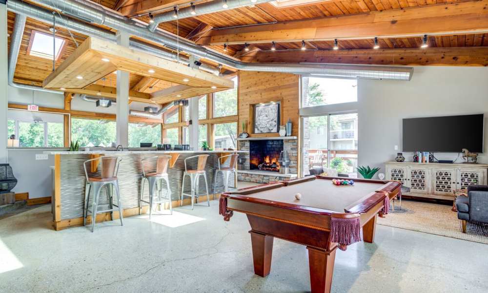 A billiard table and bar in a spacious room, perfect for gatherings and entertainment at Briarbrook in Wheaton, Illinois