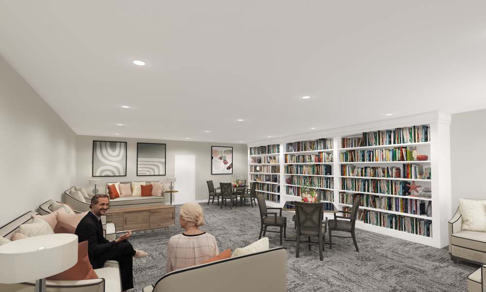 Resident library with seating at Keystone Place at Bonita Springs in Bonita Springs, Florida