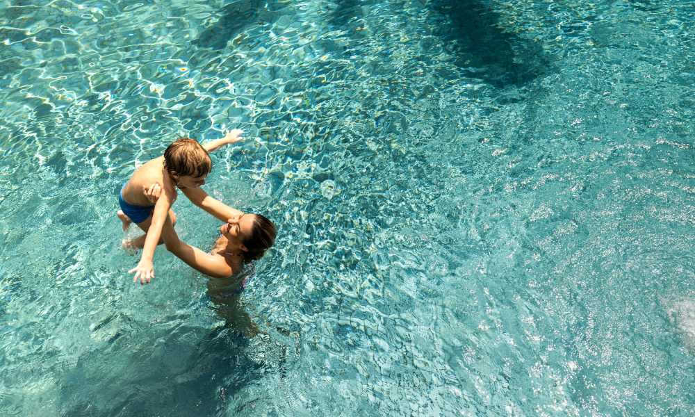 Resident and child playing in the pool at Altura in Phoenix, Arizona