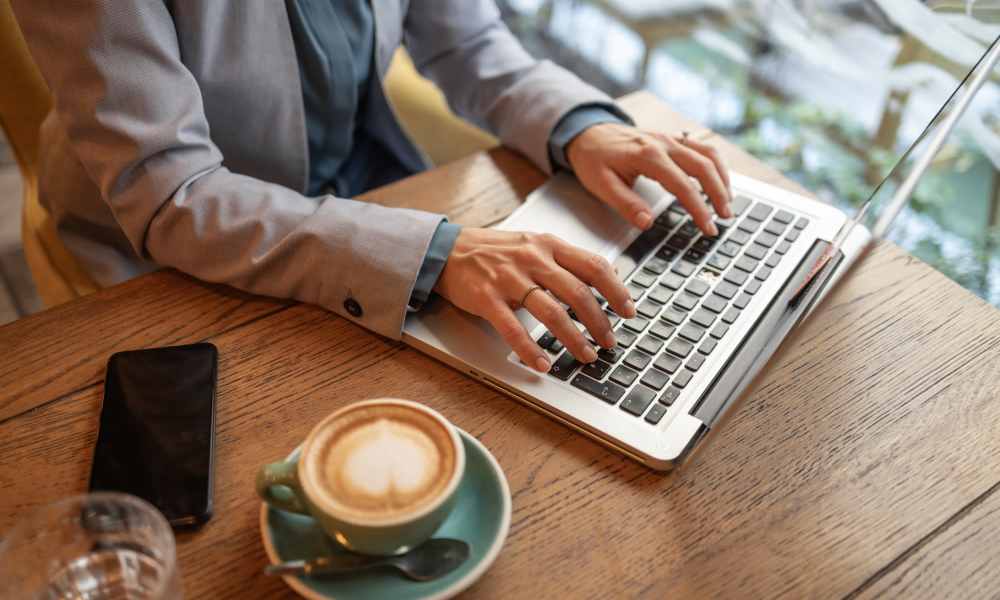 Resident typing on a laptop at a café near Sorella in Denver, Colorado