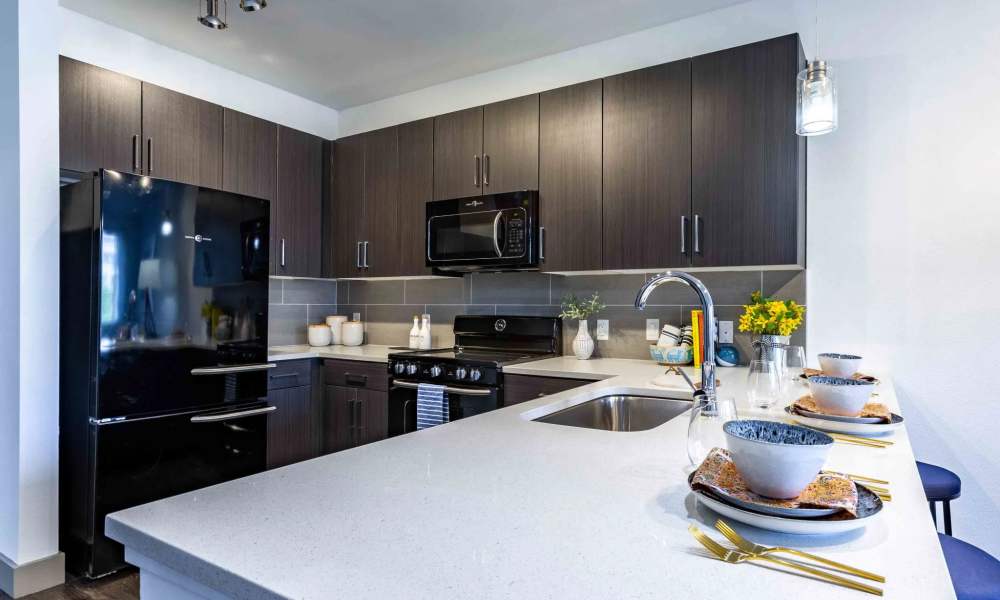 Modern kitchen with fridge and oven at Art on Highland in Phoenix, Arizona