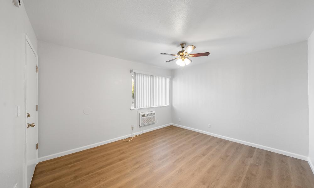 Spacious bedroom with wood-style flooring at Home Suites Apartments in Sparks, Nevada, 
