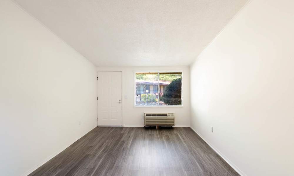 Living room with wood style flooring at The Flats at Lakeshore in Fort Oglethorpe, Georgia