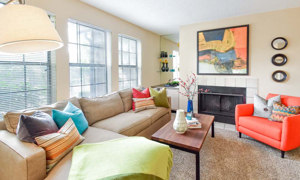 Bright living room with large windows at Park Laureate Apartments & Townhomes in Louisville, Kentucky, 