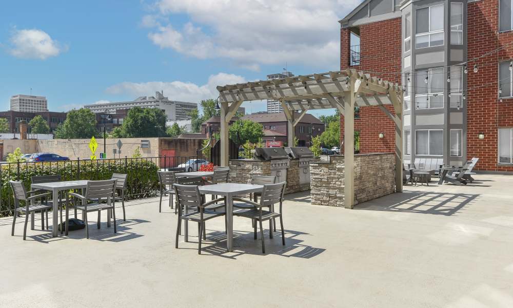 Out side lounge with barbeque setup at The Pointe at St. Joseph Apartment Homes in South Bend, Indiana