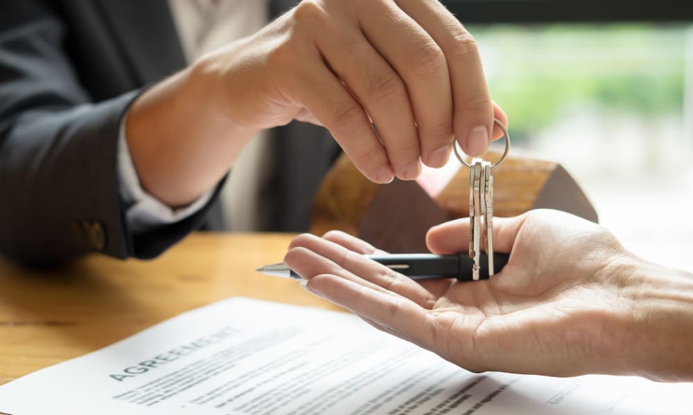 Property manager handing over keys at Home Corp Management in Panama City Beach, Florida