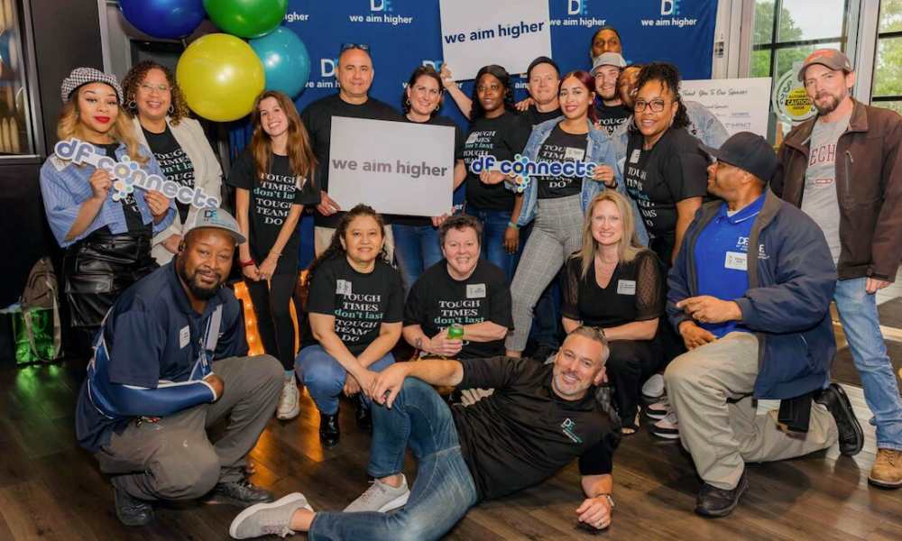 Group of employees holding posing for a photo at Drucker + Falk in Newport News, Virginia