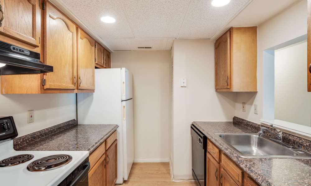 Kitchen with wooden cabinets and stainless-steel appliances at Vantage Pointe West Apartment Homes in Cincinnati, Ohio