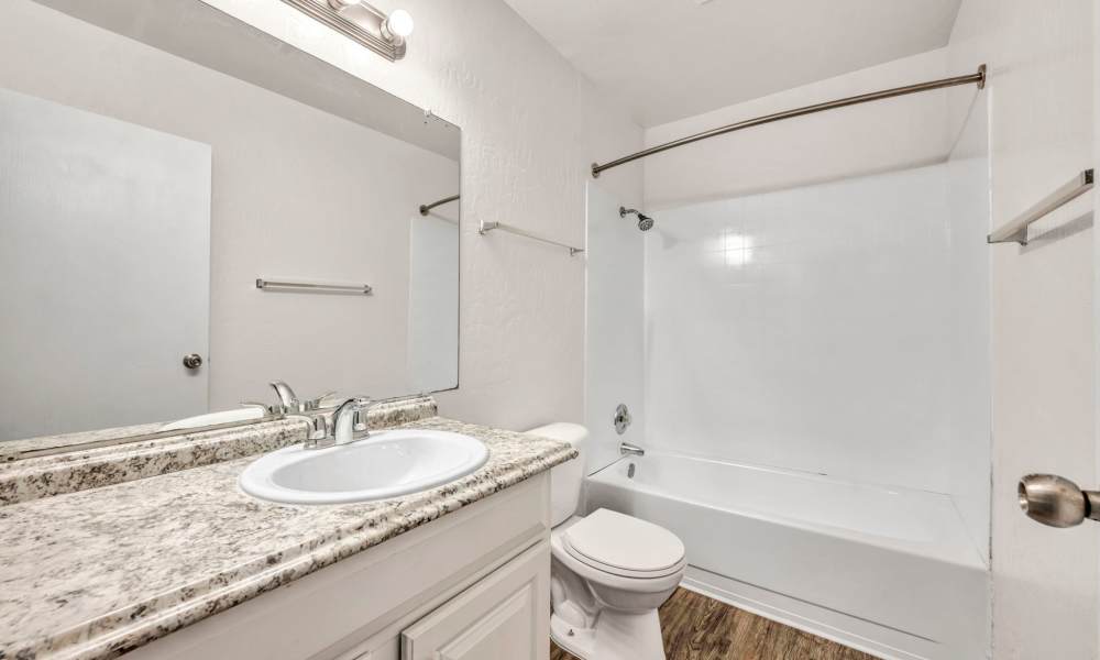 Bathroom with a mirror at Riverwood Apartments in Reno, Nevada