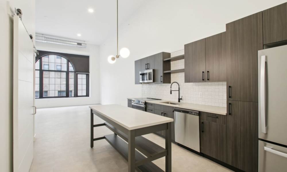 Subway tile backsplash and modern appliances in a model home's kitchen at The Edmond in Rochester, New York