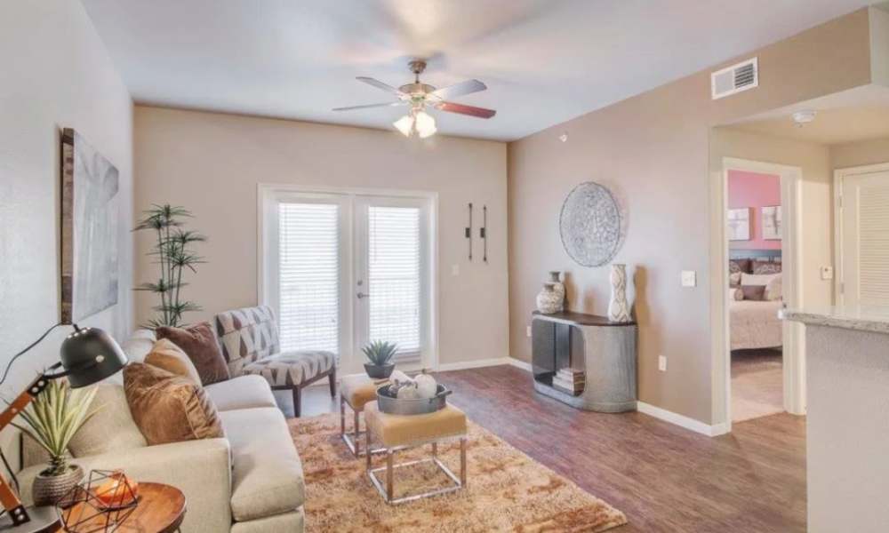 Spacious living room with sliding glass door and flush carpet at Vistas at Red Creek in , Texas