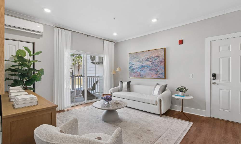 Specious living room with access to balcony at Everett at Port Wentworth in Port Wentworth, Georgia
