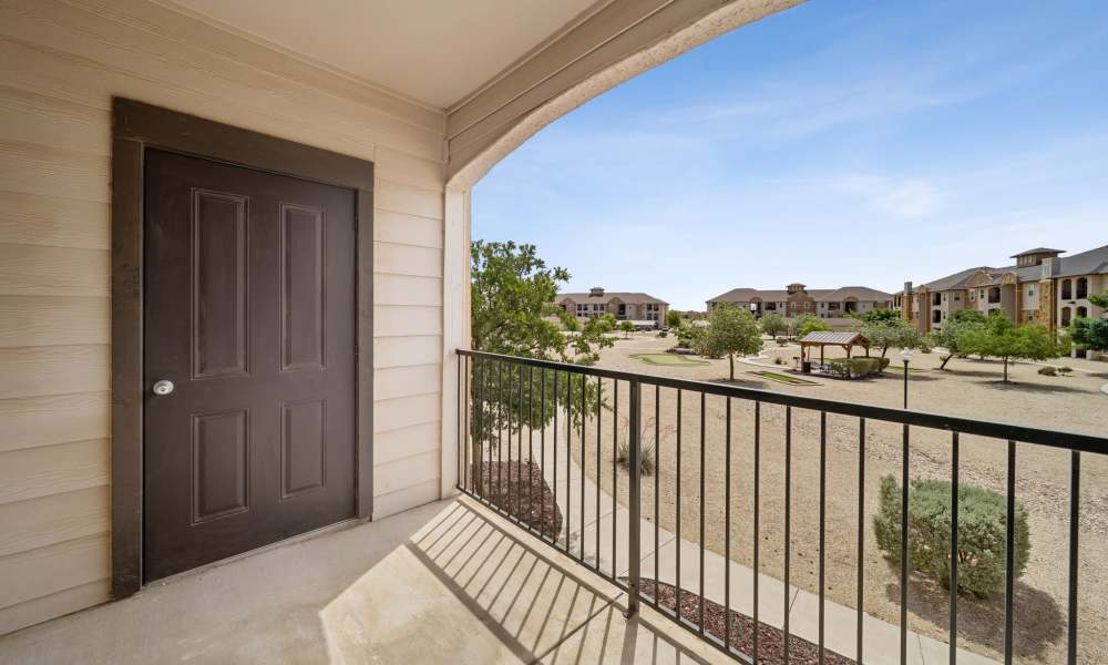 Outdoor balcony with railing and storage closet at Sunset Lodge in Odessa, Texas