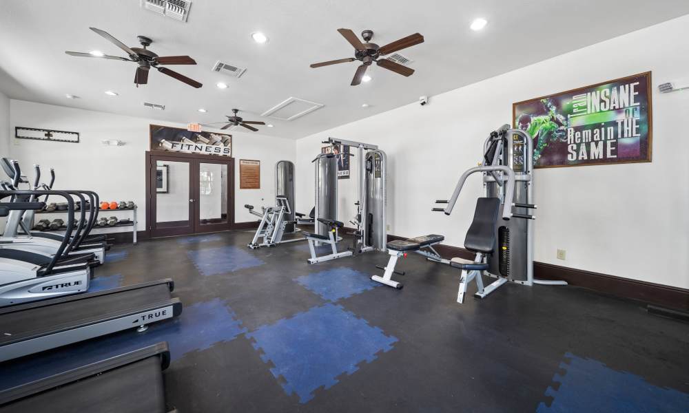 Modern fitness center with weight training equipment at Sunset Lodge in Odessa, Texas