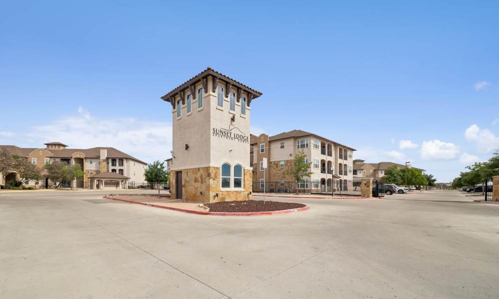 Street view of monument sign and entry gates at Sunset Lodge in Odessa, Texas