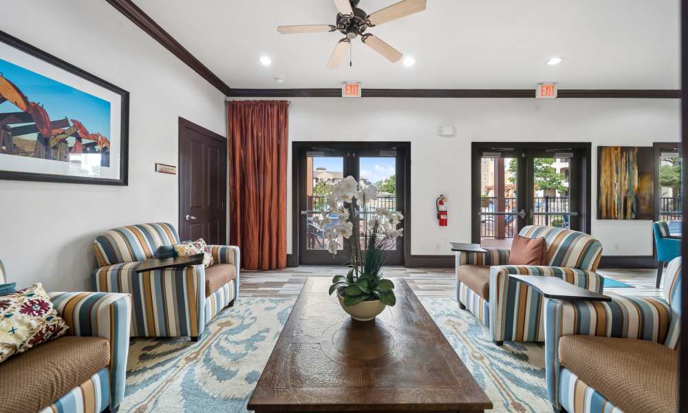 Sitting area in clubhouse with pool area entry door in background at Sunset Lodge in Odessa, Texas