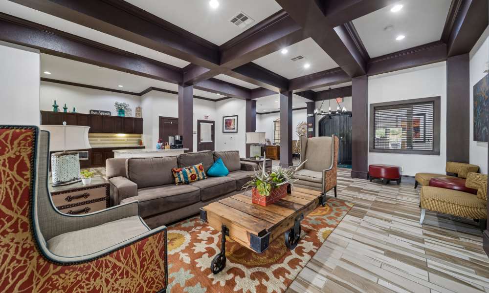 Well-decorated clubhouse with kitchen in background at Sunset Lodge in Odessa, Texas