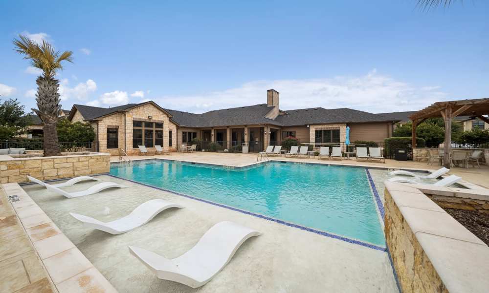 Resort style swimming pool with lounge seating and canopy at Vistas at Red Creek in San Angelo, Texas