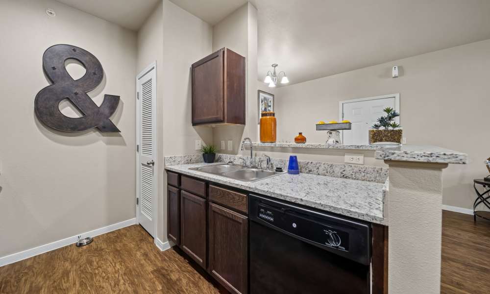 Kitchen with black appliances and pantry at Vistas at Red Creek in San Angelo, Texas