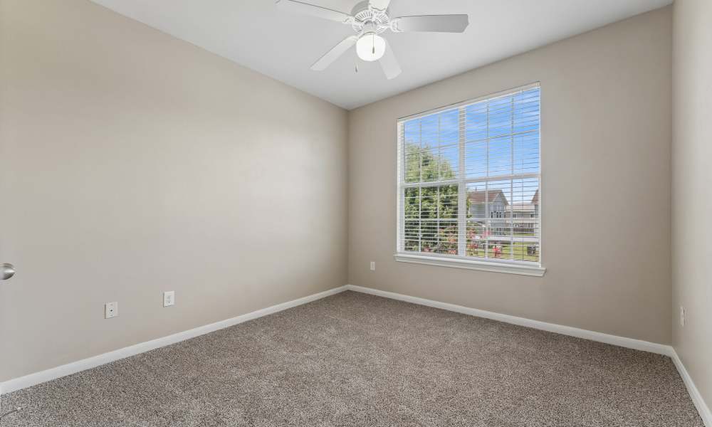 Cozy bedroom with carpeted flooring at Point Royale Apartments in Victoria, Texas