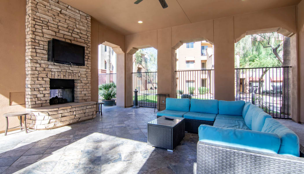 Covered seating near the outside fireplace at The Residences at Stadium Village in Surprise, Arizona