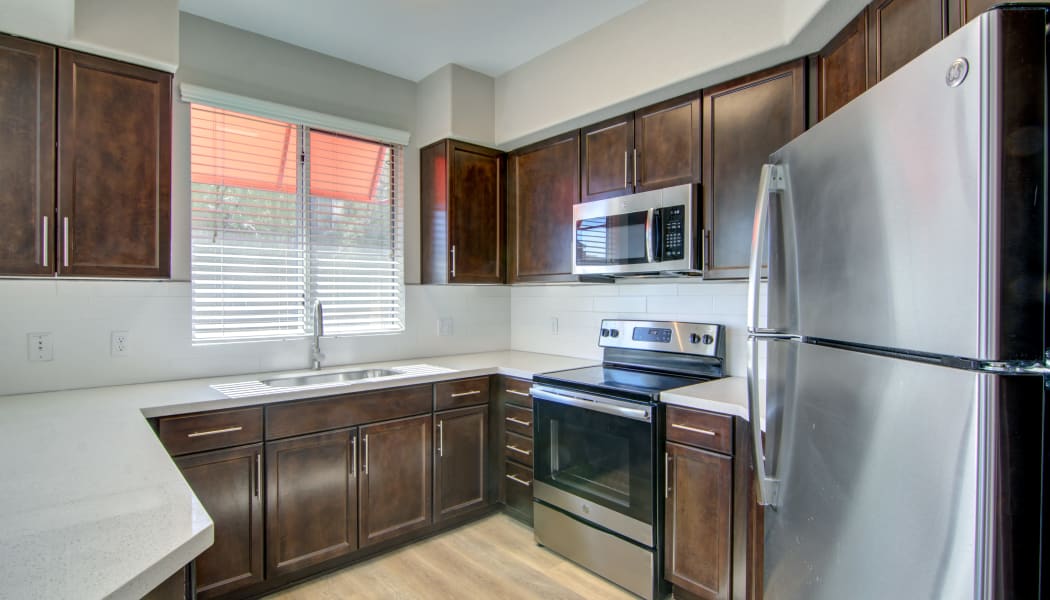 Gourmet kitchen with granite countertops in a model home at The Residences at Stadium Village in Surprise, Arizona