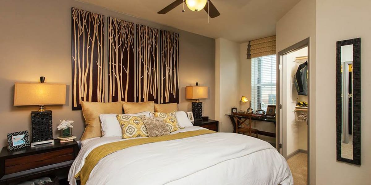 Cozy bedroom with ceiling fan at Harvest Station Apartments in Broomfield, Colorado